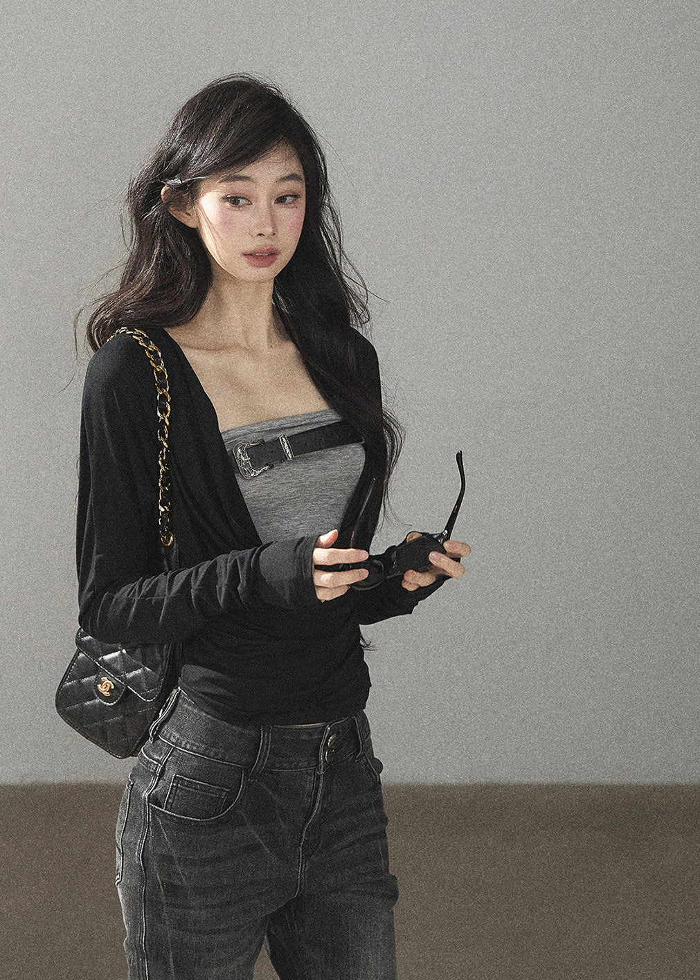 Black waist-fit draped top with gray inner layer