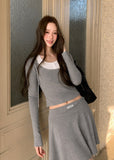 Gray hooded waist-cinching top with a coordinating pleated mini skirt