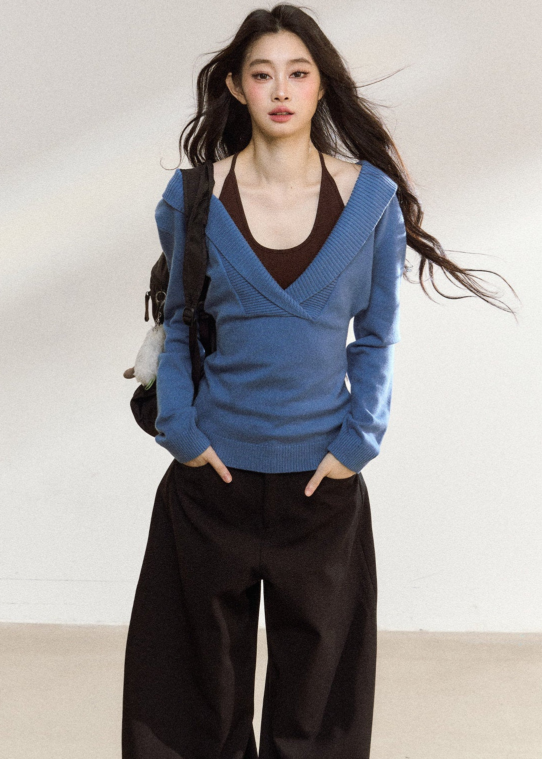 Blue asymmetric knit top with a wide foldover neckline