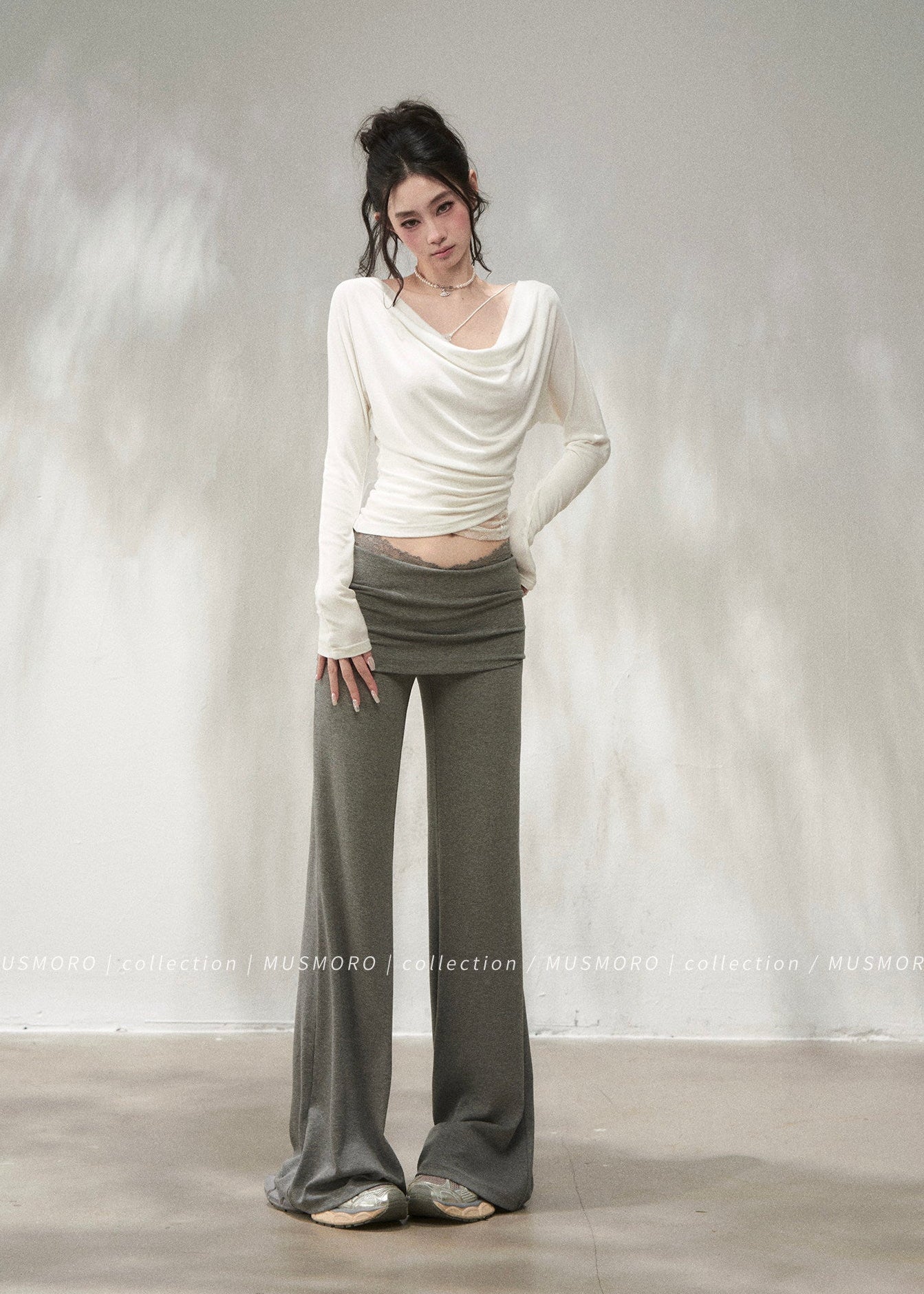 Fitted grey knit top with ruched waist and lace-trim inner layer