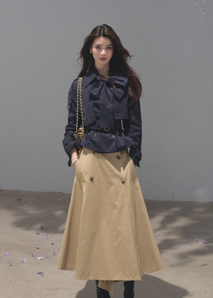 Khaki A-line midi skirt featuring asymmetric buttons and waist straps