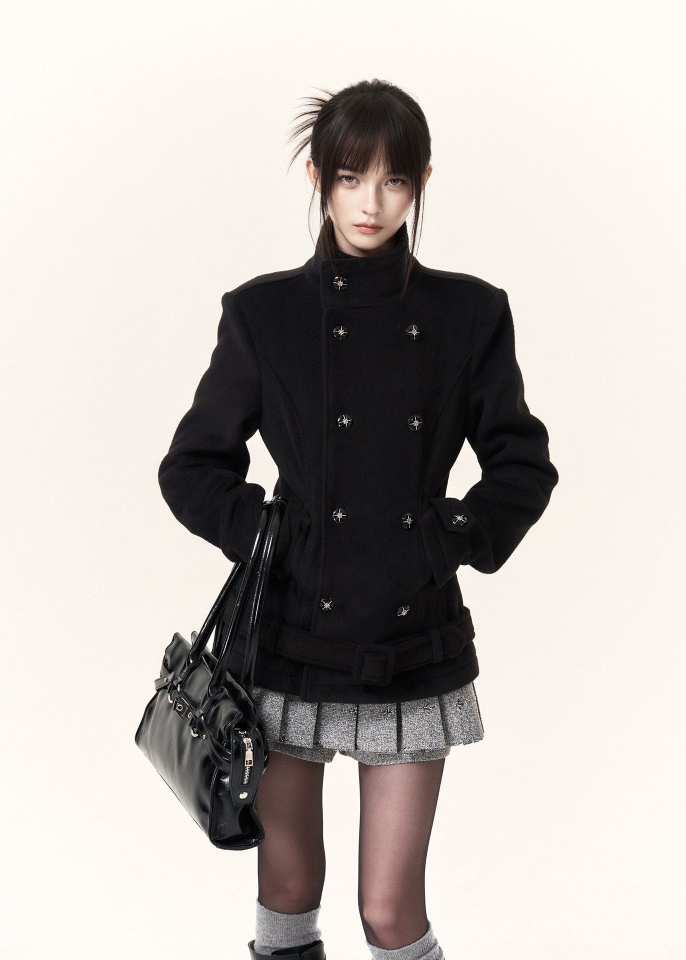 Heather grey pleated skirt shorts styled with black knee-high boots