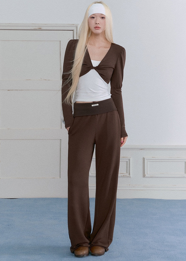Model wearing a blue-gray ballet-inspired long-sleeve top and pants set