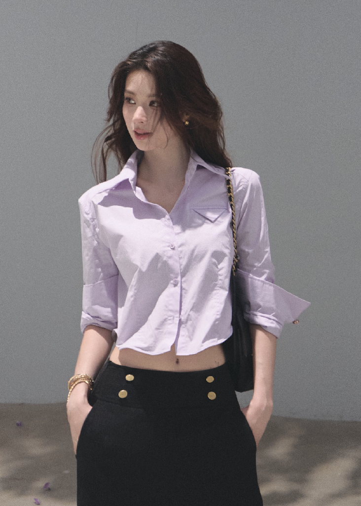 Woman wearing a lilac cropped cotton shirt with folded sleeves