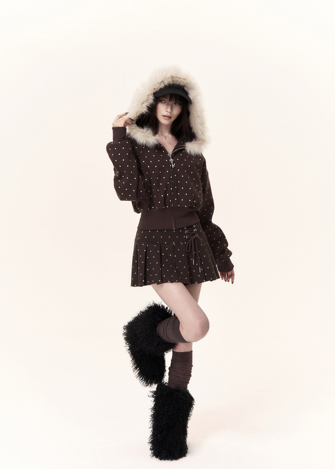 feminine polka dot hooded jacket styled with pleated mini skirt