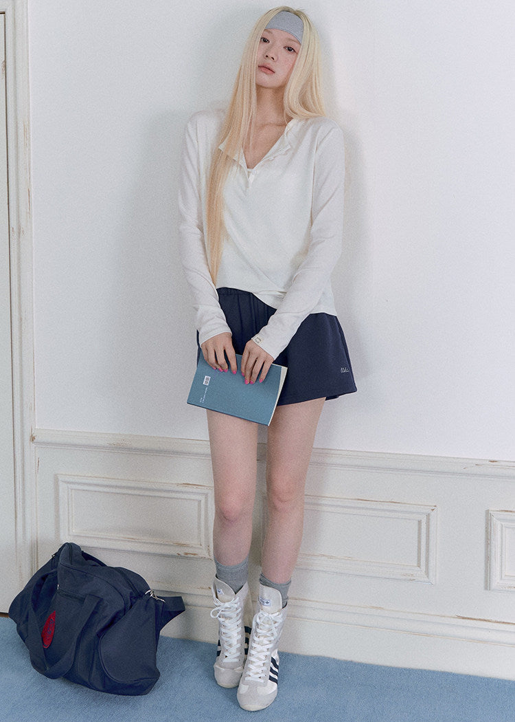 Model wearing a Tencel-wool Henley long-sleeve top