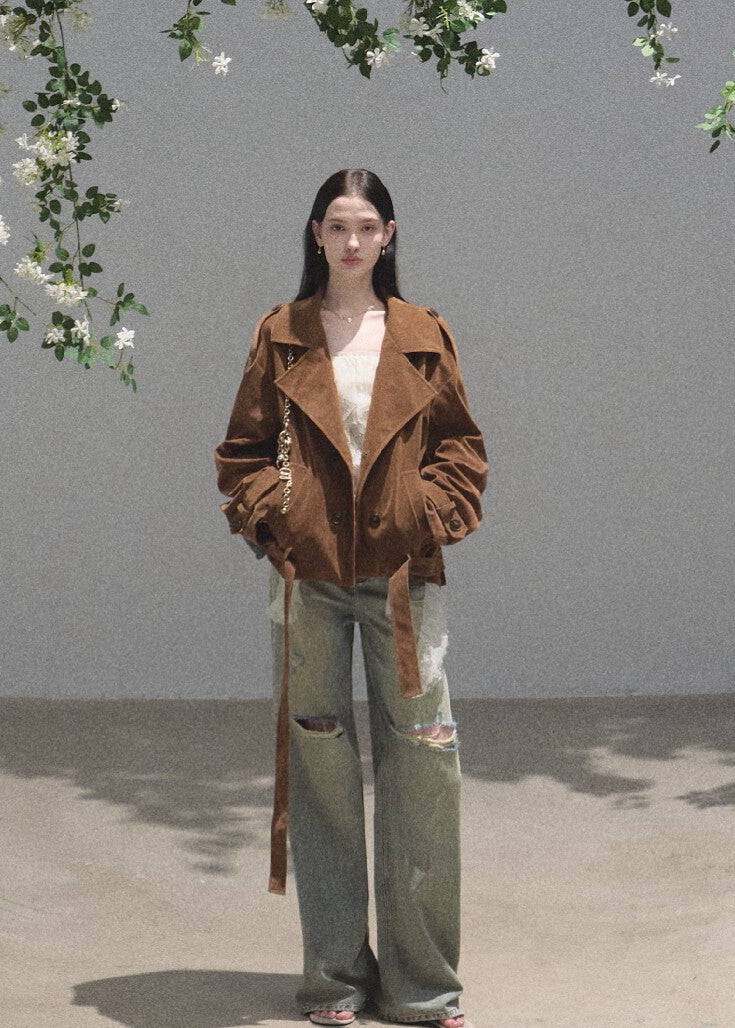 Model wearing distressed green wide-leg jeans with a cropped top