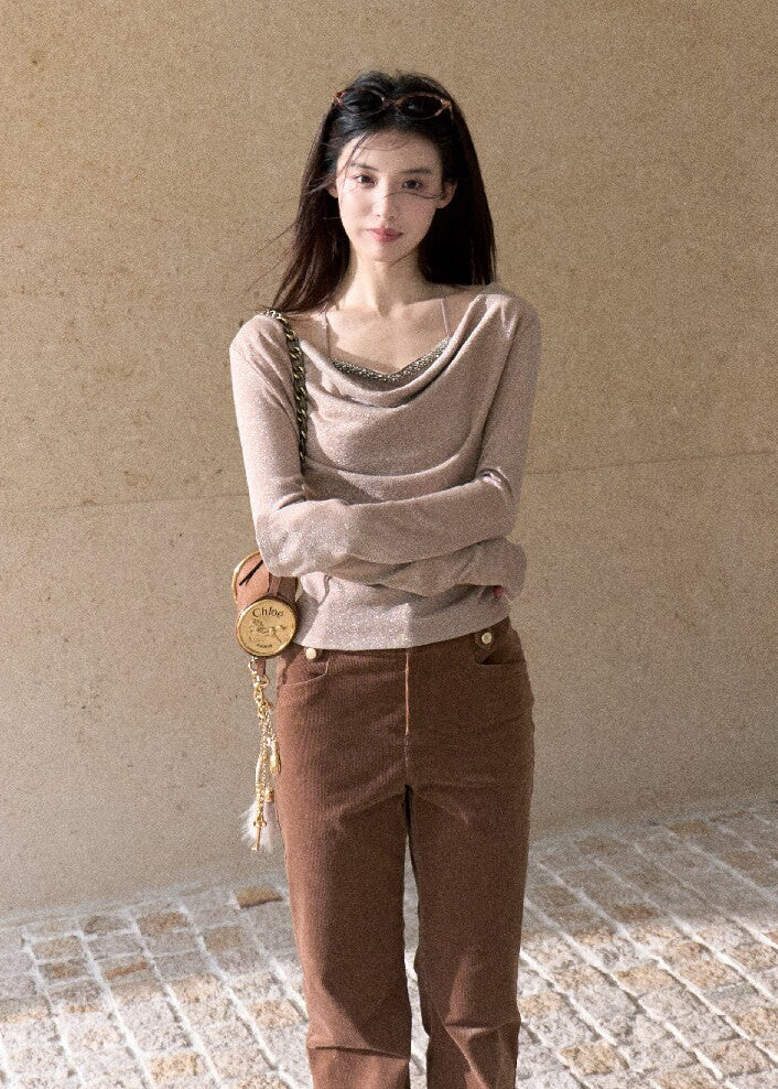 Elegant off-shoulder long sleeve top styled with brown trousers