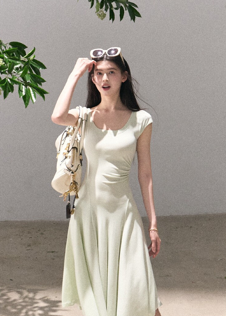 Soft green sleeveless midi dress with elegant drape