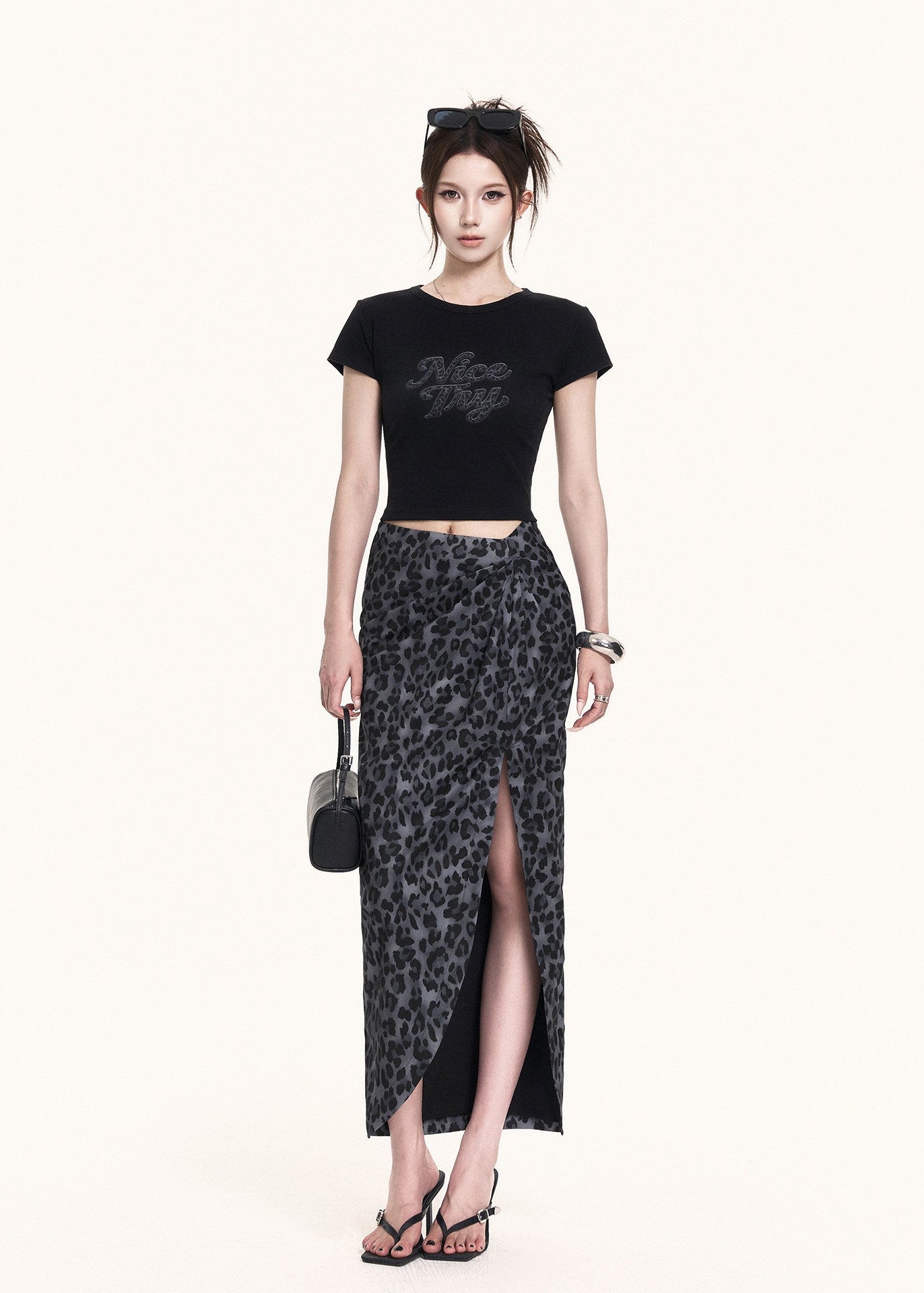 Edgy leopard skirt set styled with a small black handbag