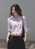 Woman wearing a lilac cropped cotton shirt with folded sleeves