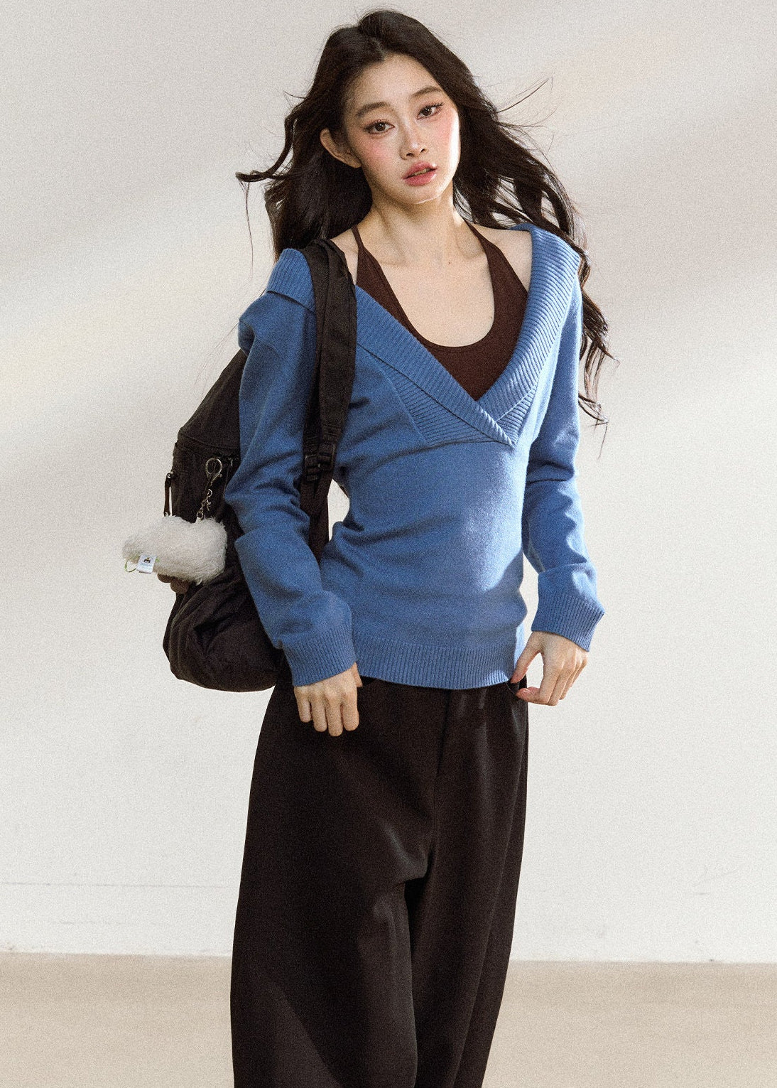 Blue asymmetric knit top with a wide foldover neckline