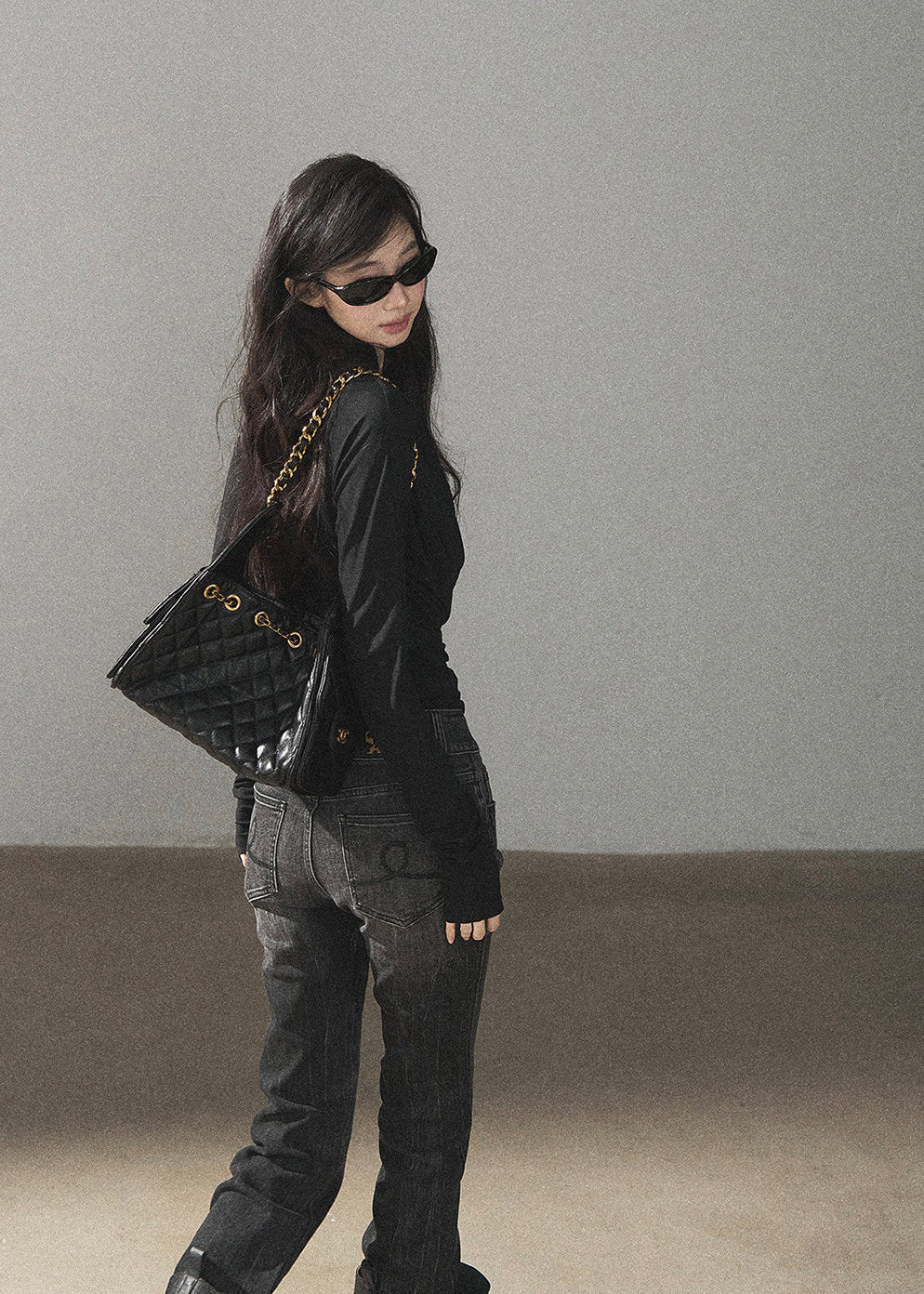 Black waist-fit draped top with gray inner layer