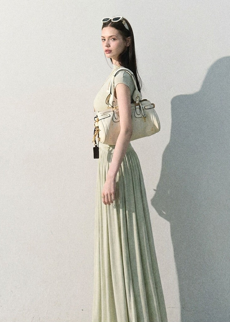 Model wearing a soft knit maxi dress with fluid drape