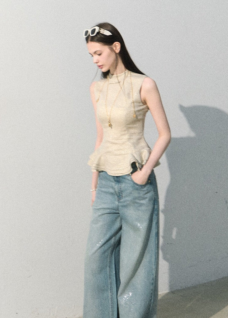 Elegant sleeveless top with a soft peplum silhouette