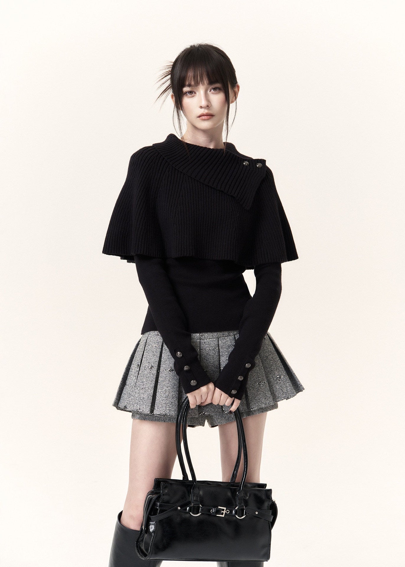 Black asymmetric cape layered knit top with button-detail neckline