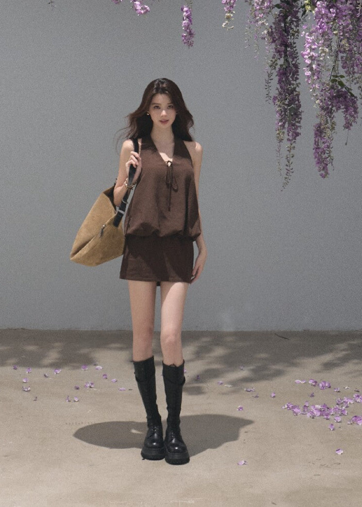 Brown sleeveless halter mini dress with a relaxed flowing silhouette