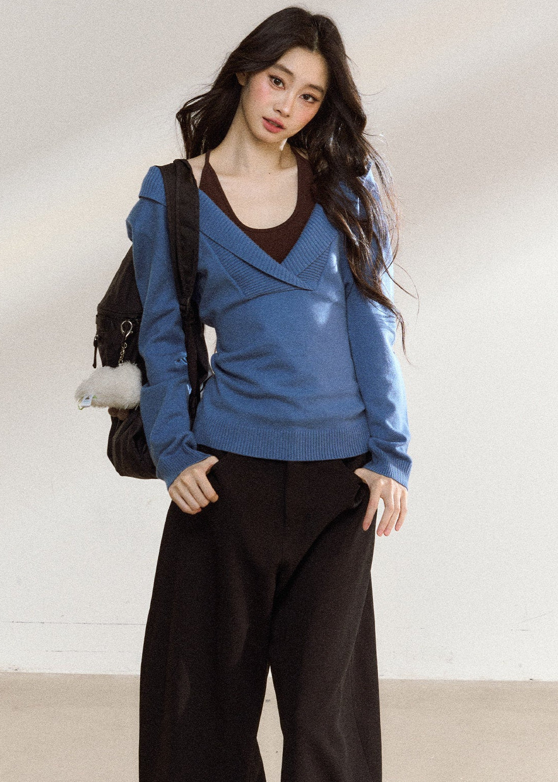 Women’s blue wrap-front sweater with relaxed shoulders