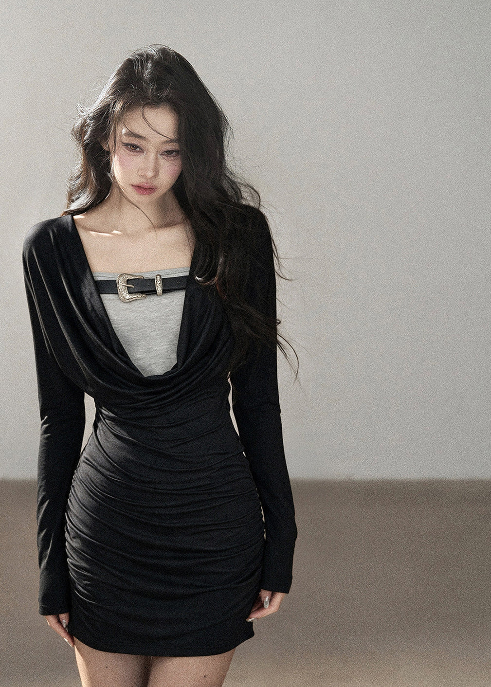 Black waist-fit draped top with gray inner layer