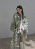 Oversized faded denim jacket with distressed details and gold-tone buttons