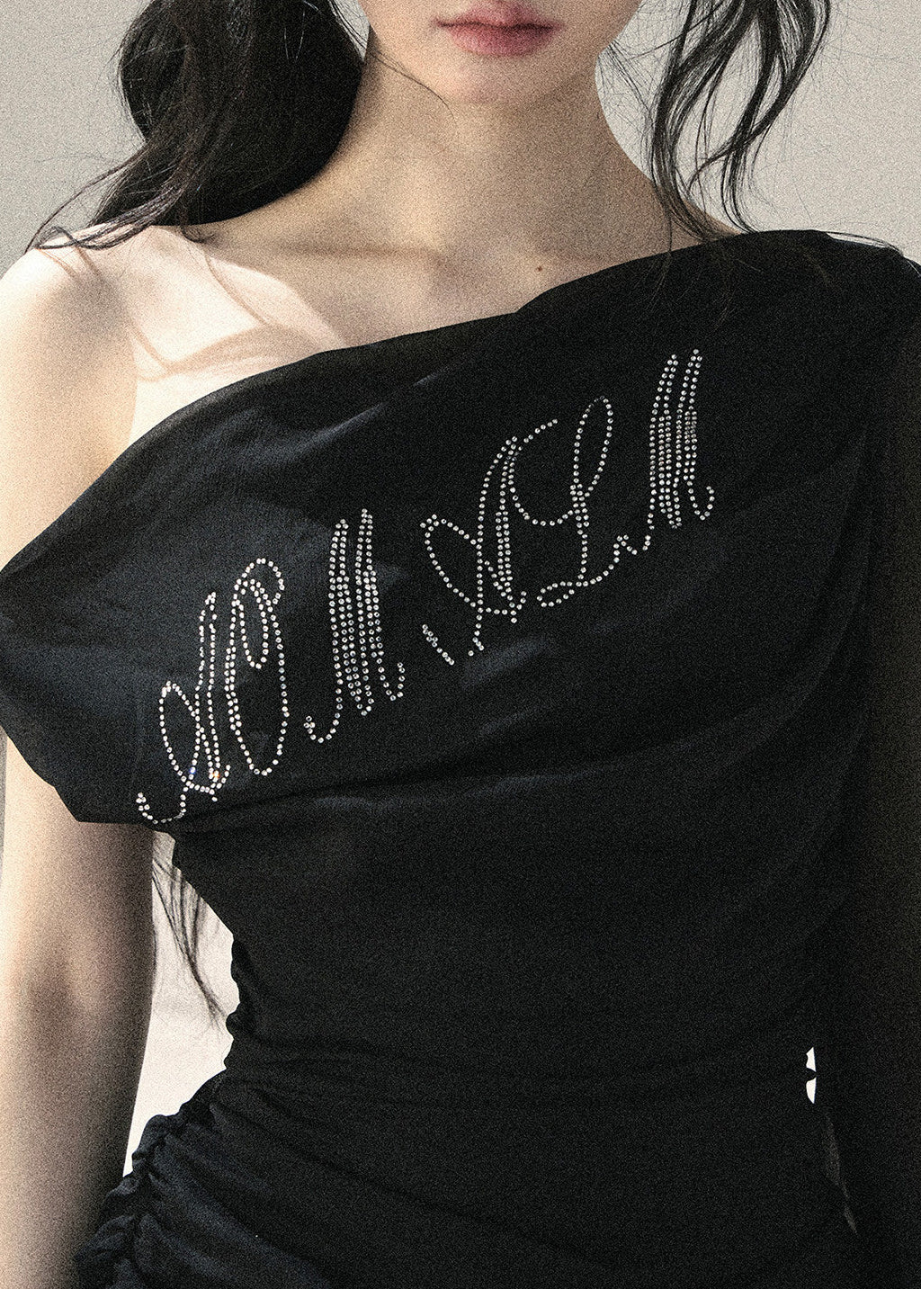 Black fitted off-shoulder top with sparkling front detail