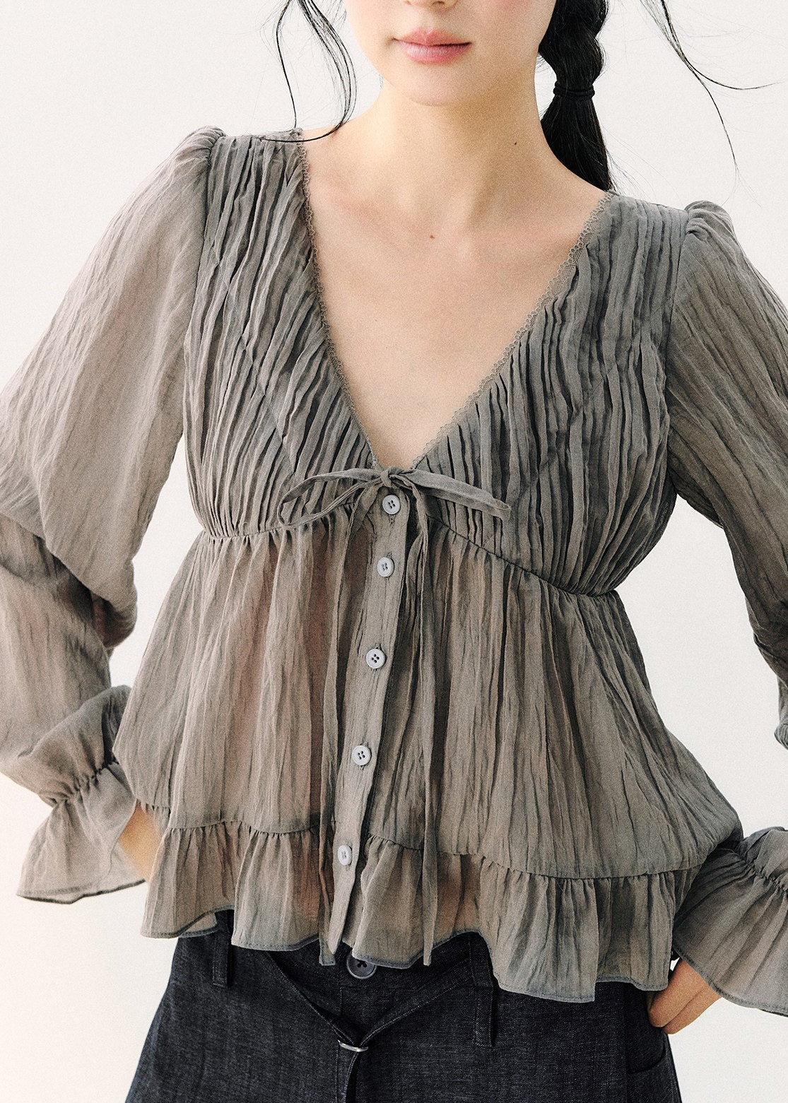 Lightweight gray long-sleeve blouse with a flowing hem