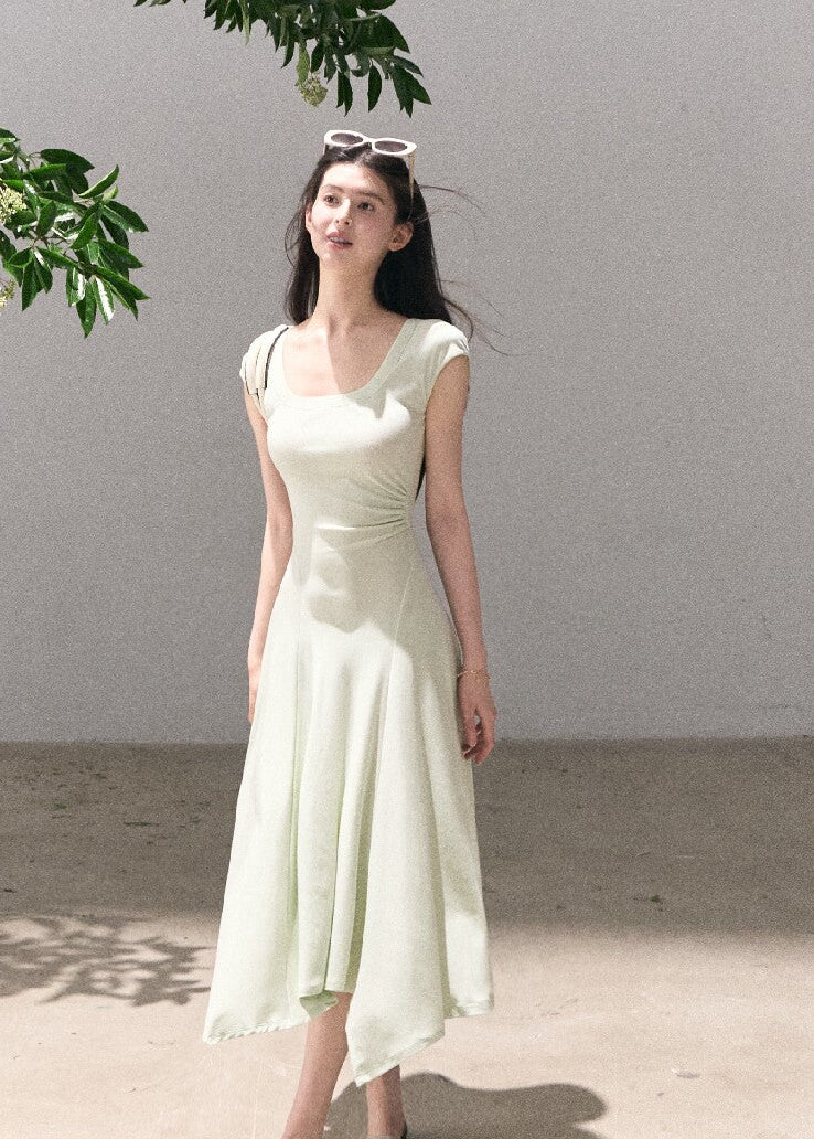 Soft green sleeveless midi dress with elegant drape