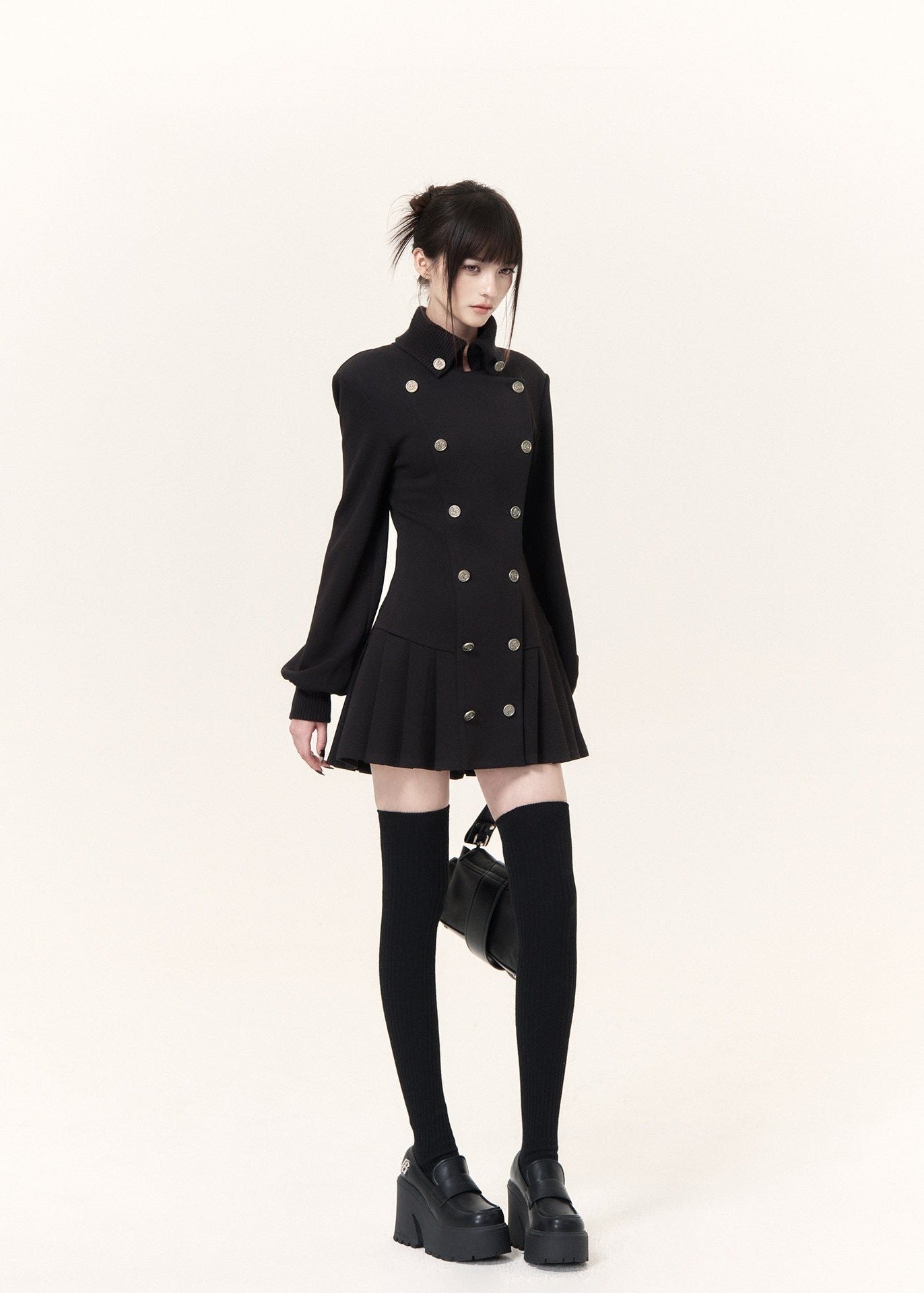 Military-inspired black mini dress with stand collar and pleated hem