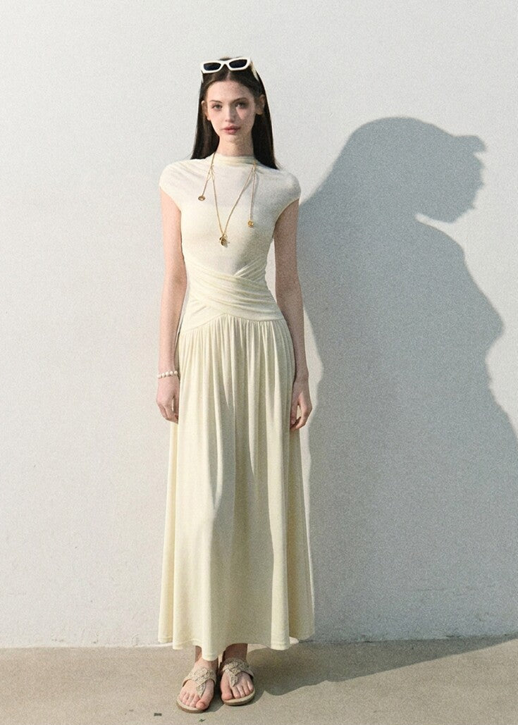 Draped waist long dress styled with a shoulder bag