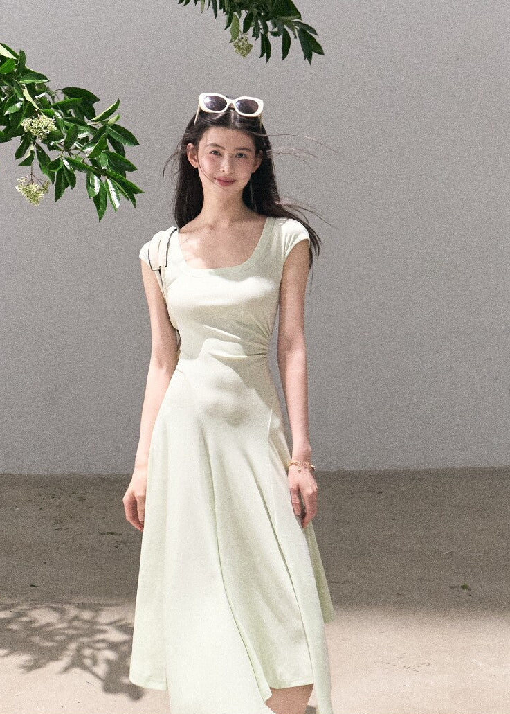 Soft green sleeveless midi dress with elegant drape