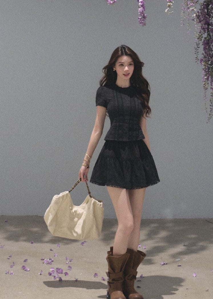 Black fitted top with a matching tiered cake mini skirt