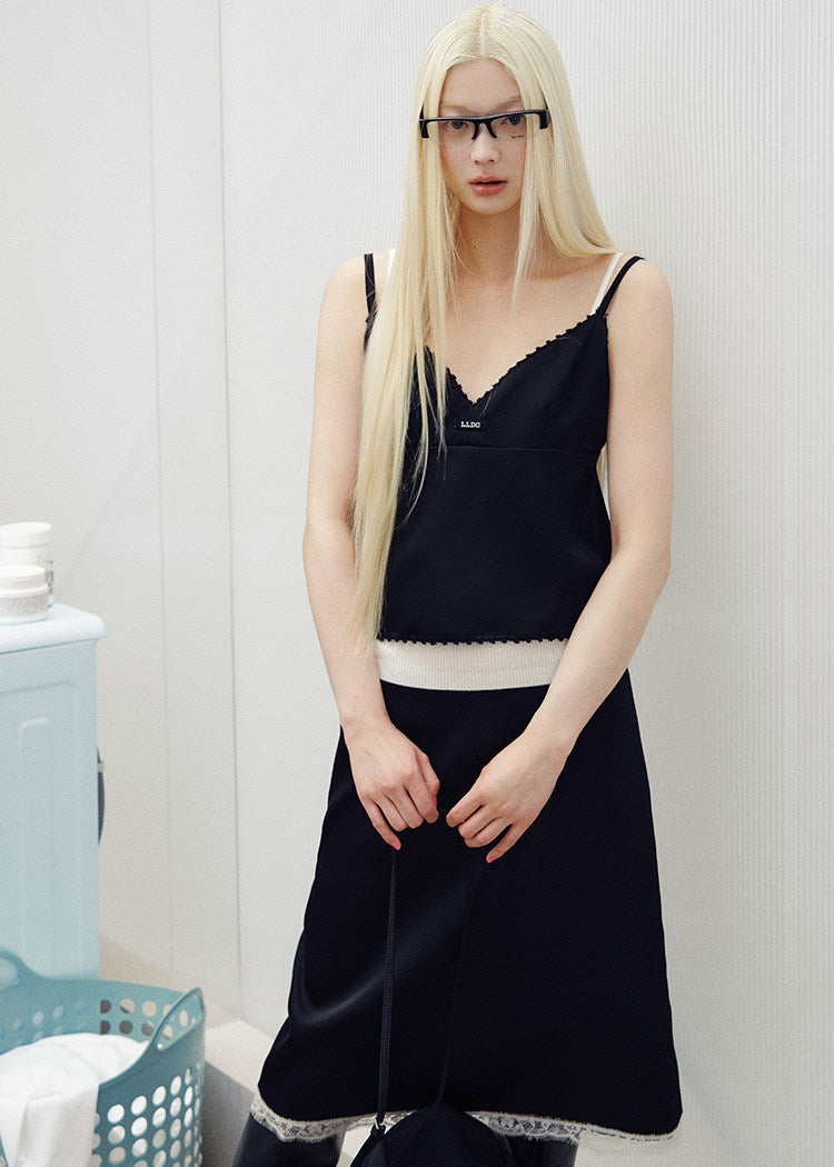 Models wearing pink and black lace-trim camisole and midi skirt sets