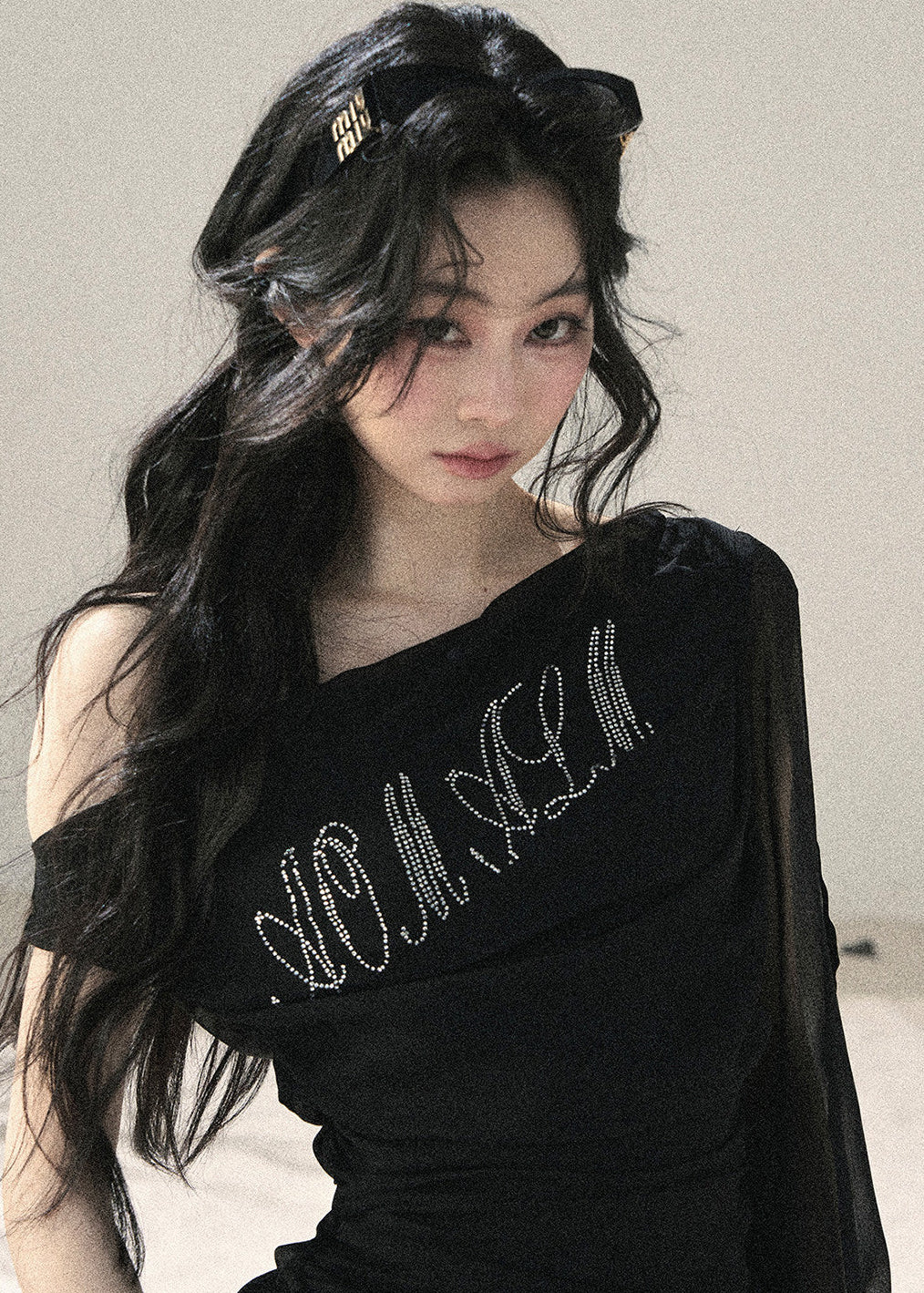 Black fitted off-shoulder top with sparkling front detail