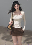 Fitted cream long-sleeve T-shirt styled with washed denim