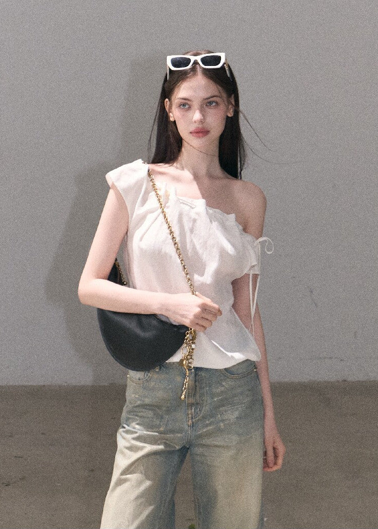 Model wearing an ivory draped top and loose pants