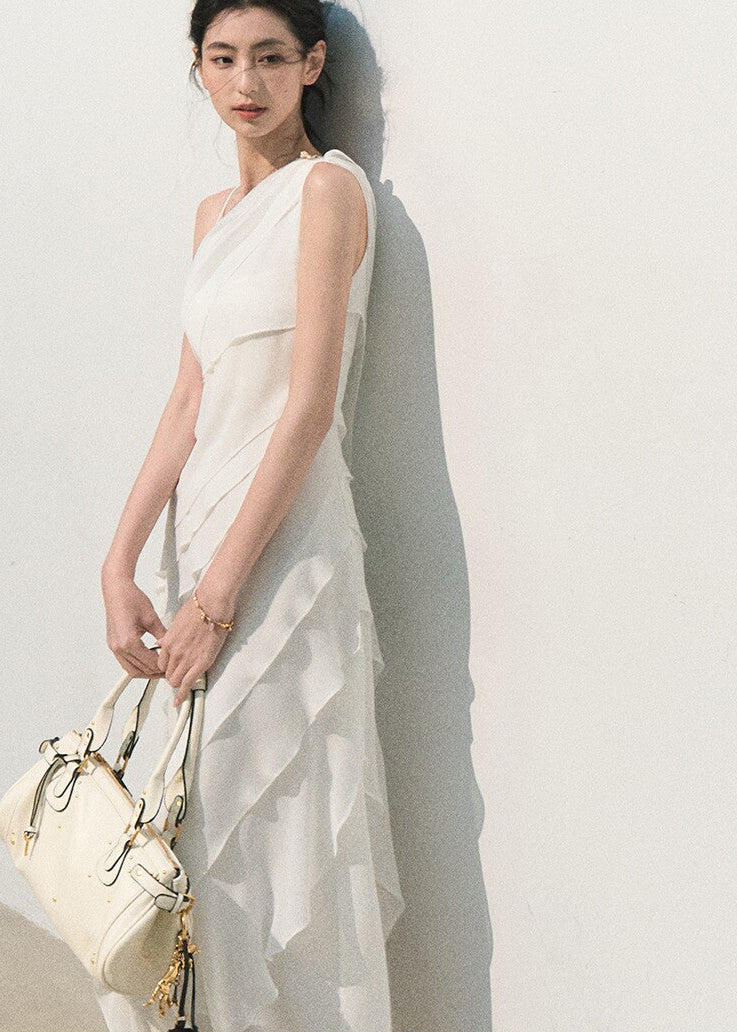 Side detail of a white asymmetrical ruffle dress