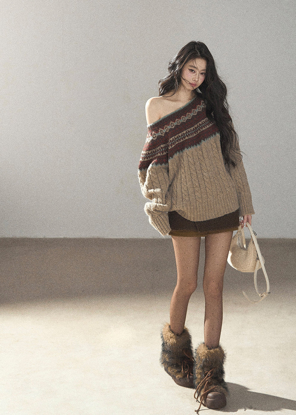 Fair Isle patterned beige knit sweater styled with brown mini shorts