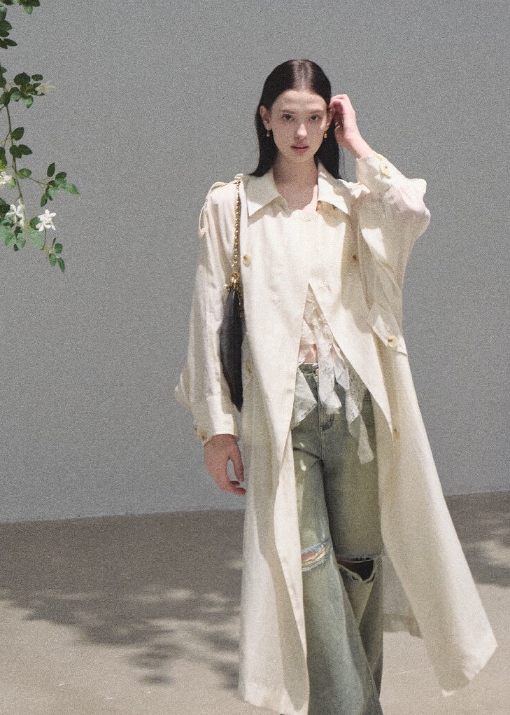 Floor-length ripped denim jeans in a faded moss-green wash
