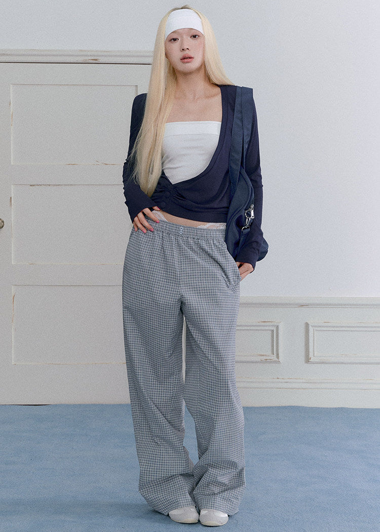 Women’s waist-defining blue knit top with an asymmetric neckline