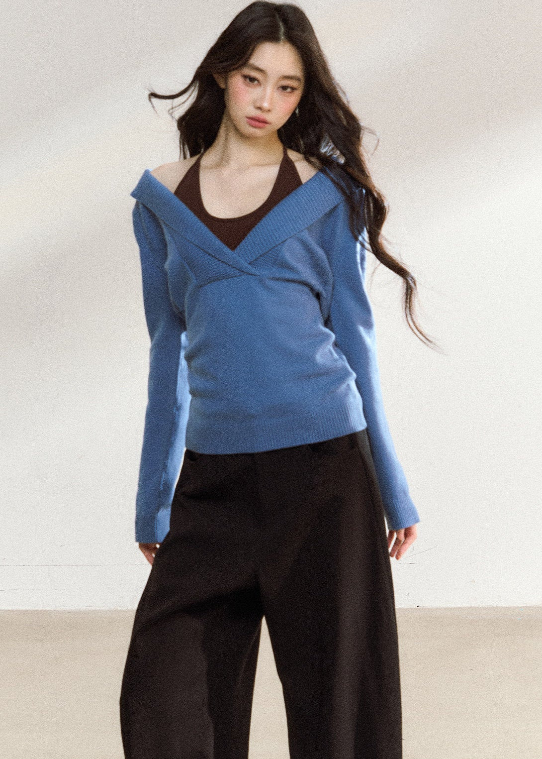 Women’s blue wrap-front sweater with relaxed shoulders