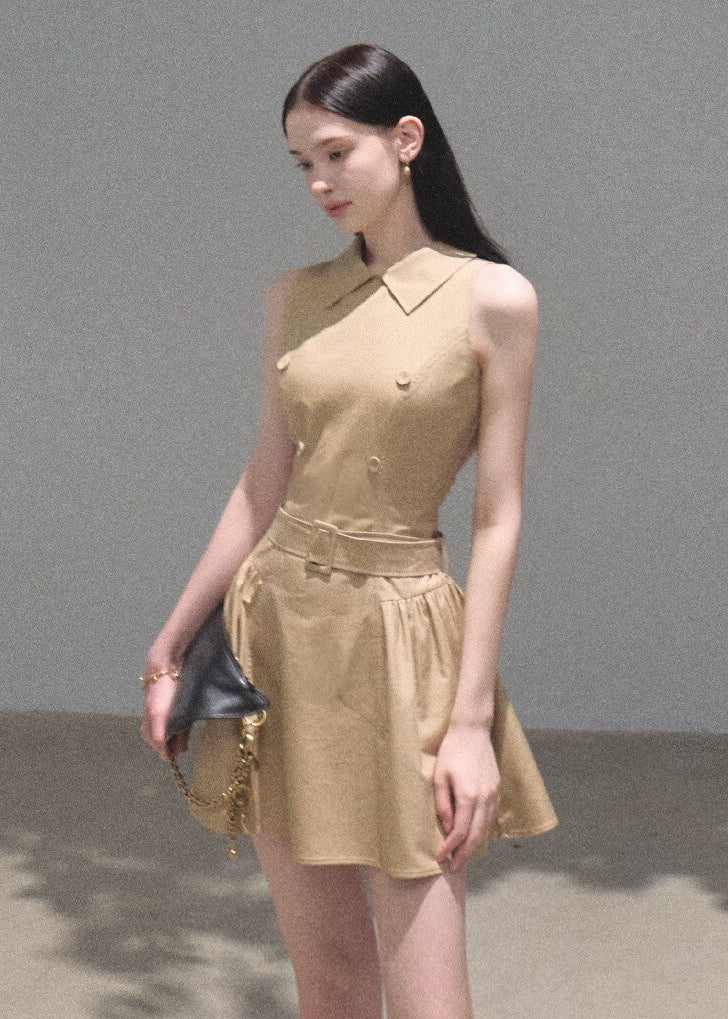 Model wearing a khaki cape-overlay mini dress with a matching belt