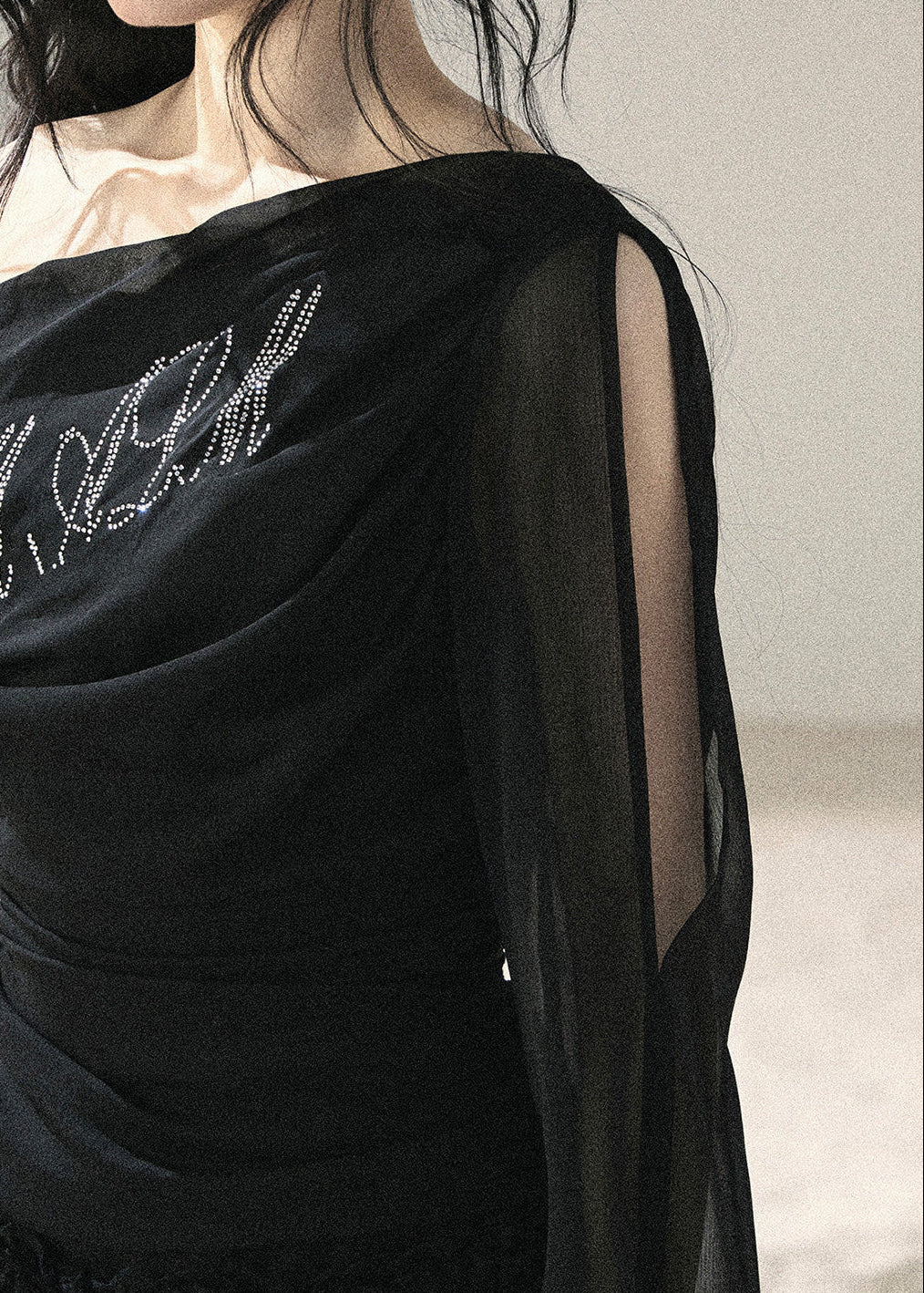 Black fitted off-shoulder top with sparkling front detail
