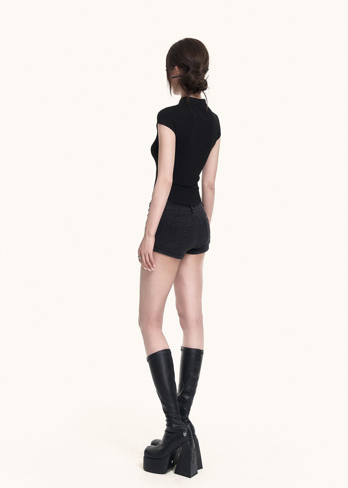 Stand-neck black top with a bold cutout detail