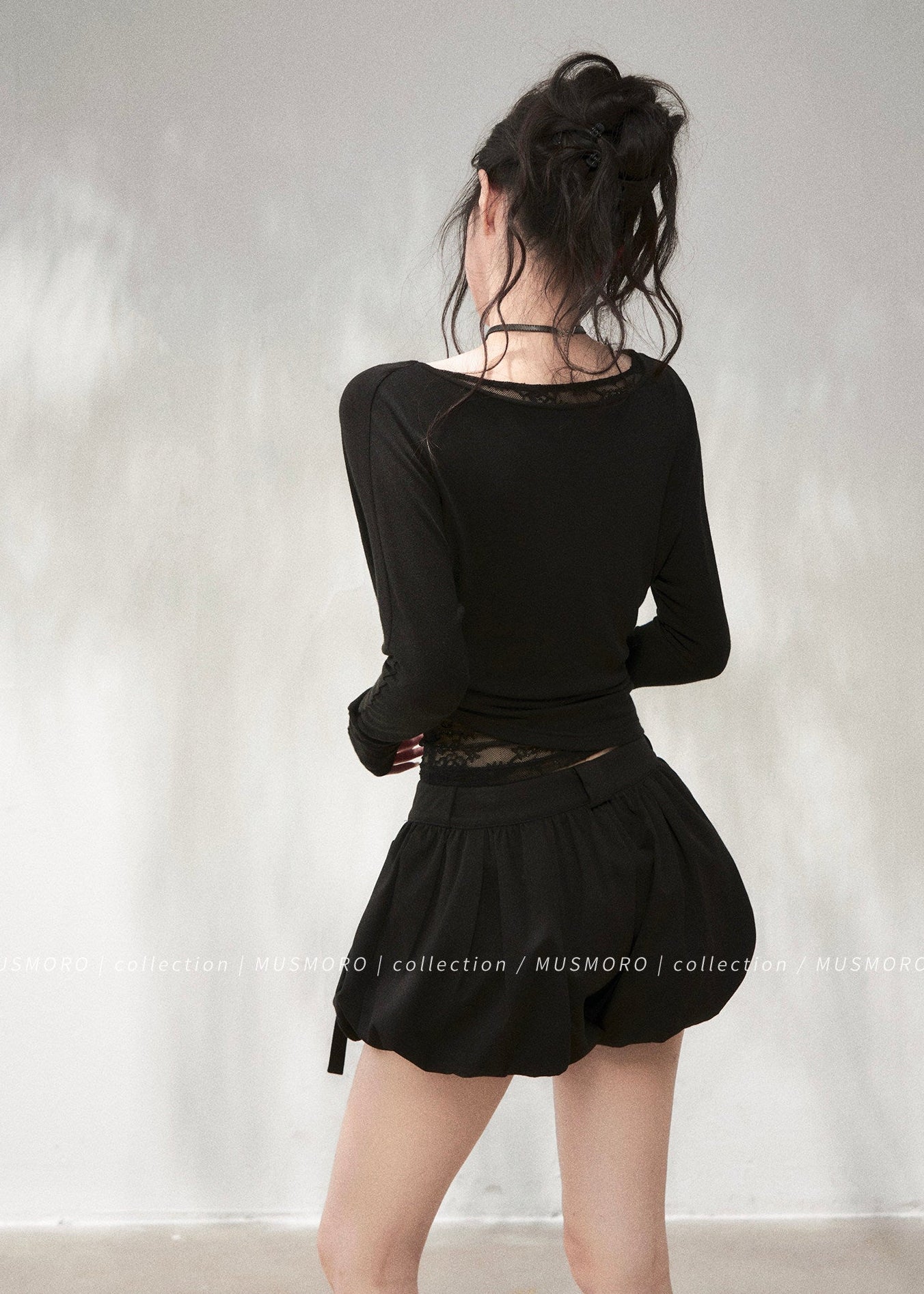 Elegant draped neck top styled with black wide-leg denim jeans