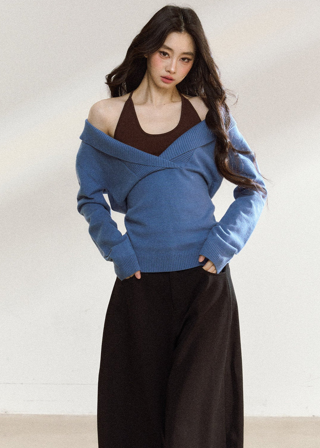 Women’s blue wrap-front sweater with relaxed shoulders