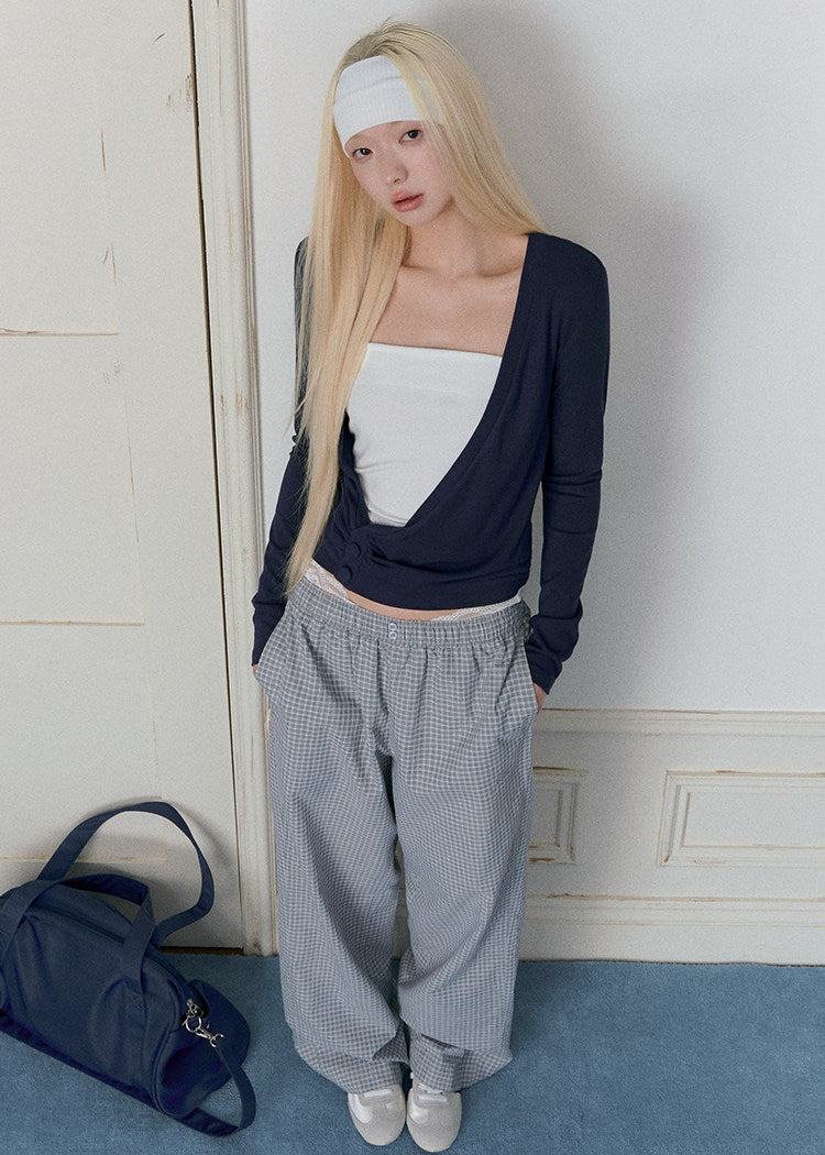 Sky-blue long-sleeve knit top with a twisted wrap front