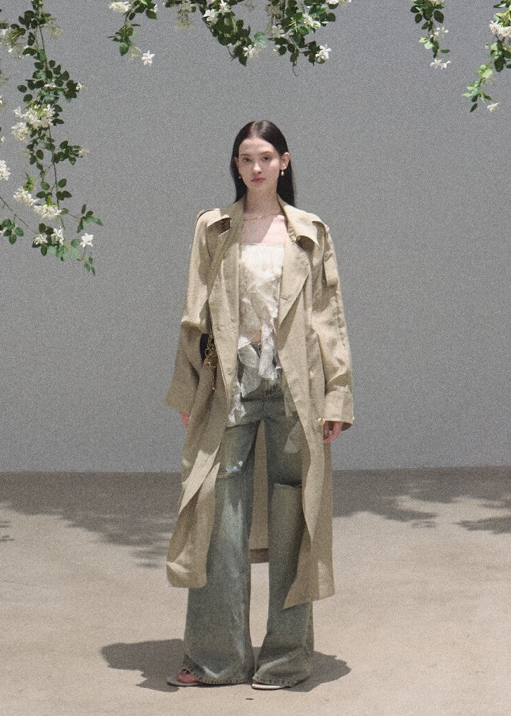 Floor-length ripped denim jeans in a faded moss-green wash