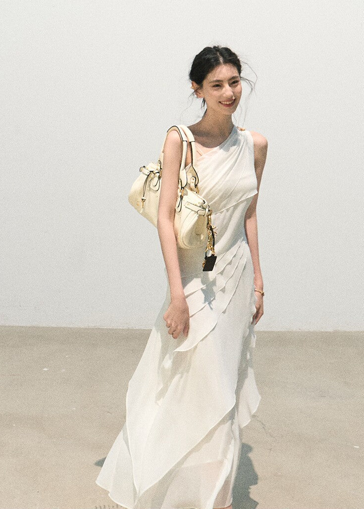 Side detail of a white asymmetrical ruffle dress