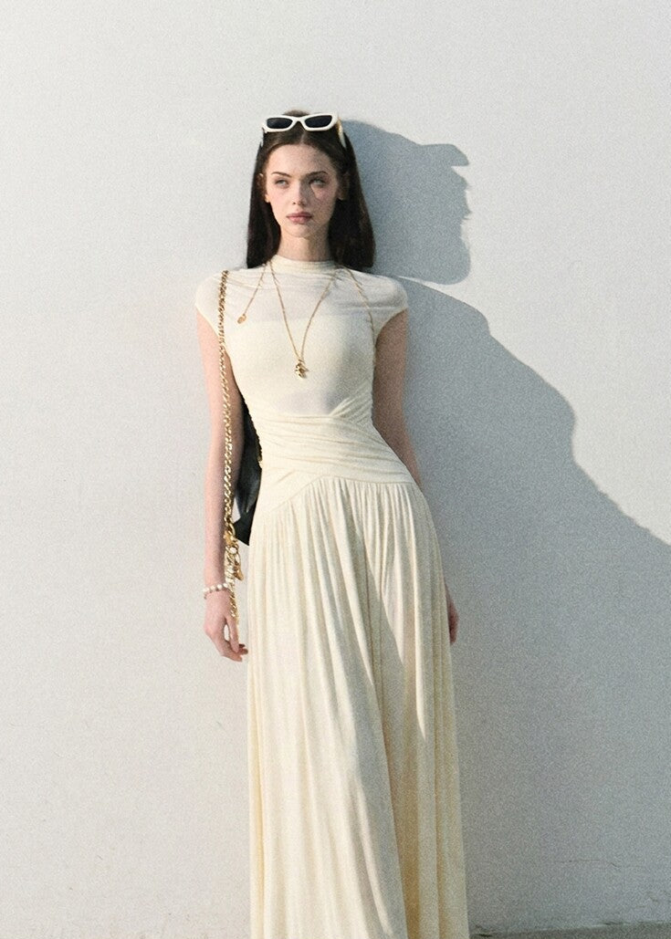 Draped waist long dress styled with a shoulder bag