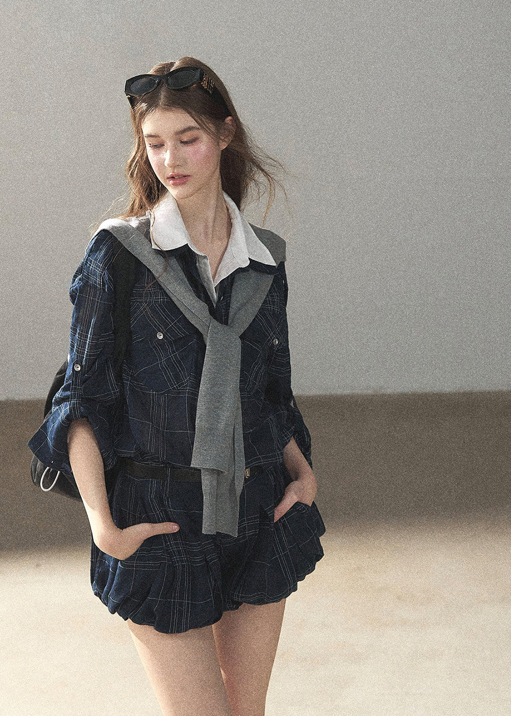Model wearing collegiate jacket and shorts set